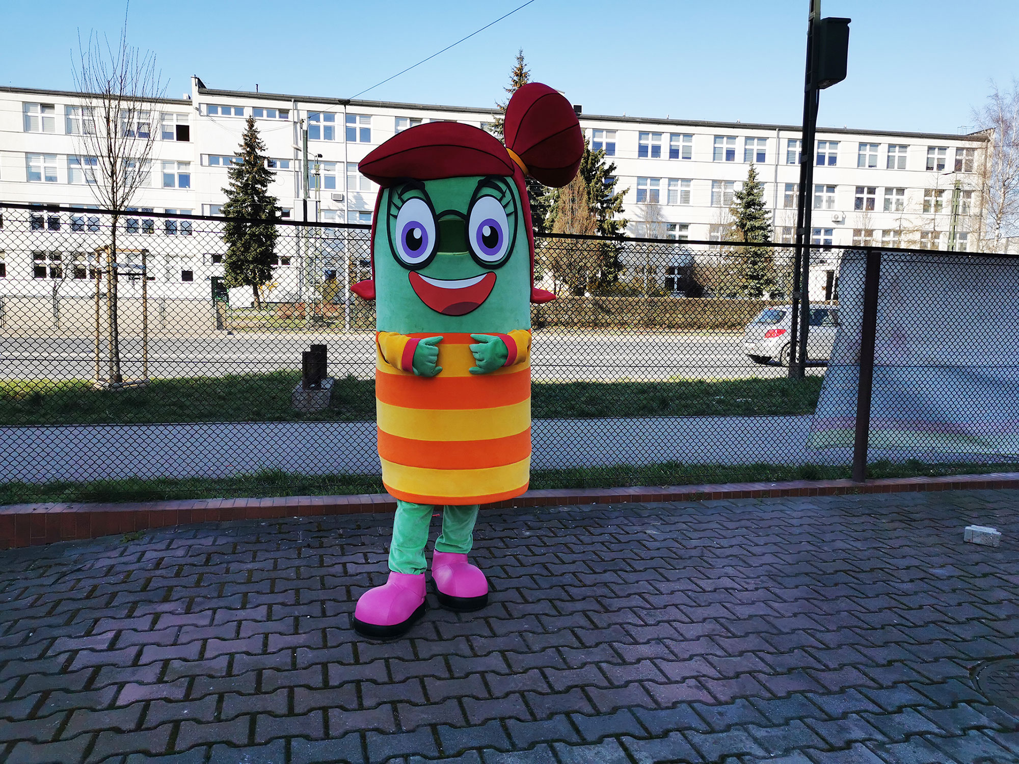 Do fotografii pozuje Strój promocyjny dziewczyna przed siedzibą firmy Elabika
